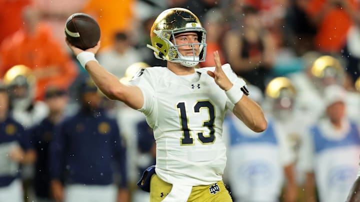 Aug 31, 2025; Miami Gardens, Florida, USA; Notre Dame Fighting Irish quarterback CJ Carr (13) drops back to pass against the Miami Hurricanes during the first quarter at Hard Rock Stadium. 