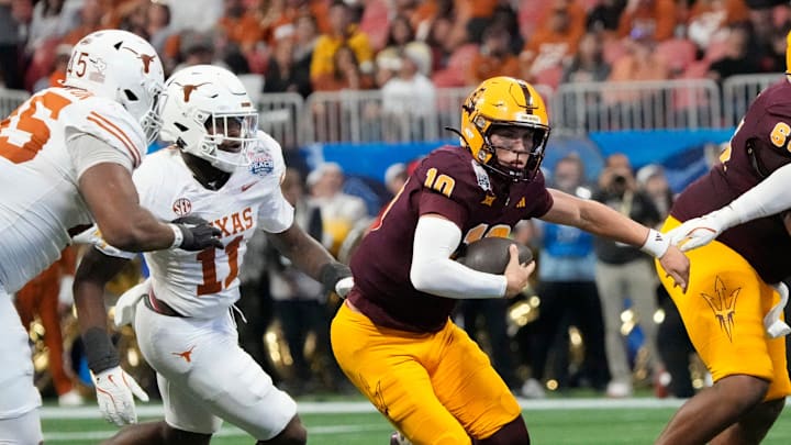 Arizona State quarterback Sam Leavitt (10) scrambles away from Texas linebacker Colin Simmons (11) during the second quarter of the Chick-fil-A Peach Bowl in Atlanta on Wednesday, Jan. 1, 2025.