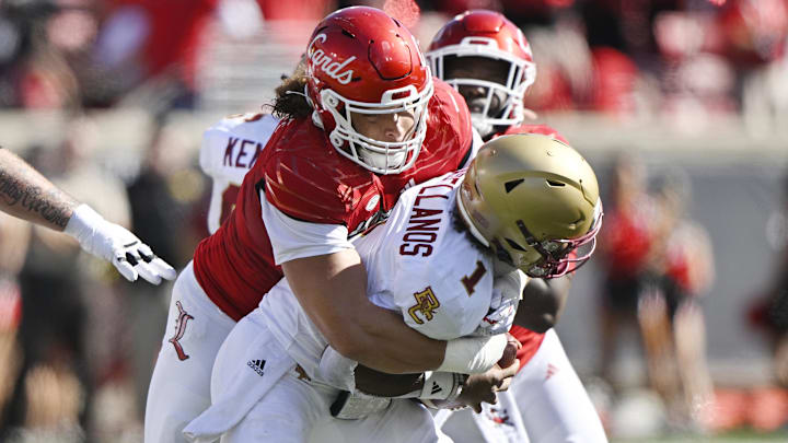 Sep 23, 2023; Louisville, Kentucky, USA; Louisville Cardinals defensive lineman Ashton Gillotte (9) sacks Boston College Eagles quarterback Thomas Castellanos (1) during the first half at L&N Federal Credit Union Stadium. Mandatory Credit: Jamie Rhodes-Imagn Images Sep 23, 2023; Louisville, Kentucky, USA; Louisville Cardinals defensive lineman Ashton Gillotte (9) sacks Boston College Eagles quarterback Thomas Castellanos (1) during the first half at L&N Federal Credit Union Stadium. Mandatory Credit: Jamie Rhodes-Imagn Images