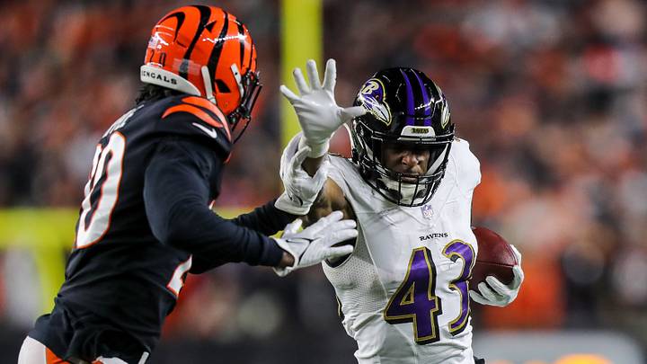 Jan 15, 2023; Cincinnati, Ohio, USA; Baltimore Ravens running back Justice Hill (43) runs with the ball against Cincinnati Bengals cornerback Eli Apple (20) in the second half during a wild card game at Paycor Stadium. Mandatory Credit: Katie Stratman-USA TODAY Sports Jan 15, 2023; Cincinnati, Ohio, USA; Baltimore Ravens running back Justice Hill (43) runs with the ball against Cincinnati Bengals cornerback Eli Apple (20) in the second half during a wild card game at Paycor Stadium. Mandatory Credit: Katie Stratman-USA TODAY Sports