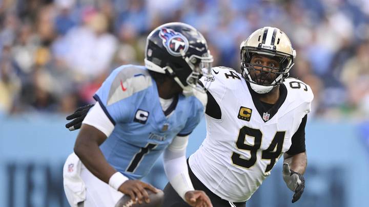 Dec 28, 2025; Nashville, Tennessee, USA;  New Orleans Saints defensive end Cameron Jordan (94) gives chase to Tennessee Titans quarterback Cam Ward (1) during the second half of the game at Nissan Stadium. Mandatory Credit: Steve Roberts-Imagn Images