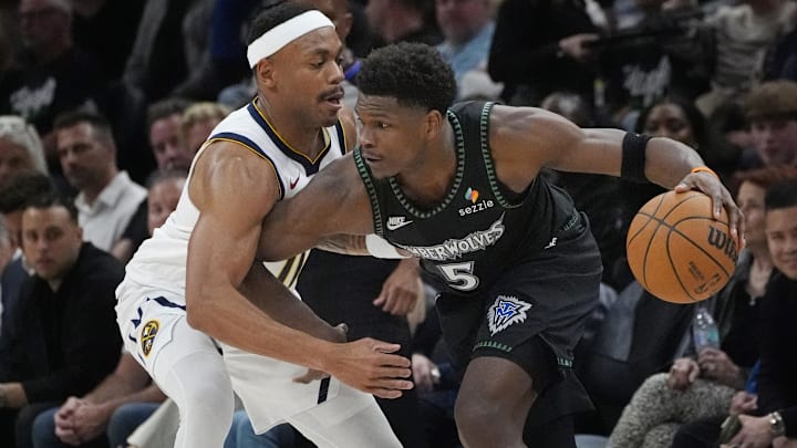 Apr 23, 2026; Minneapolis, Minnesota, USA;  Minnesota Timberwolves guard Anthony Edwards (5) works around Denver Nuggets guard Bruce Brown (11) in the fourth quarter at Target Center.