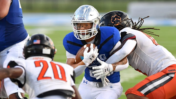 IMG running back Tyson Park (#27) is met by Cocoa High defenders Nycere Jacobs (#15) and O'Kece Battle. The IMG Academy National squad hosted the Cocoa High School Tigers Friday, Sept. 6, 2024 in Bradenton. IMG running back Tyson Park (#27) is met by Cocoa High defenders Nycere Jacobs (#15) and O'Kece Battle. The IMG Academy National squad hosted the Cocoa High School Tigers Friday, Sept. 6, 2024 in Bradenton.