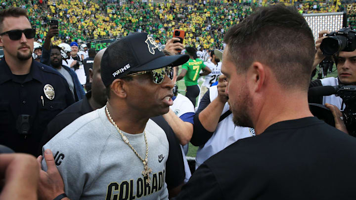 Colorado coach Deion Sanders, left, and Oregon's Dan Lanning meet at midfield after the game in Eugene Saturday, Sept. 23, 2023.