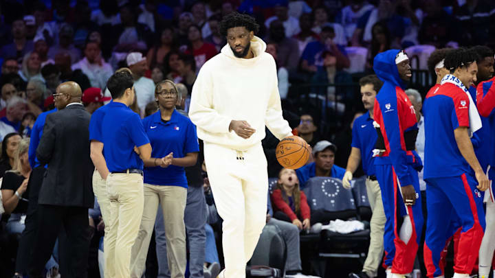Oct 23, 2024; Philadelphia, Pennsylvania, USA; Philadelphia 76ers center Joel Embiid  in plain clothes dribbles the ball during a timeout in the second quarter against the Milwaukee Bucks at Wells Fargo Center. Mandatory Credit: Bill Streicher-Imagn Images
