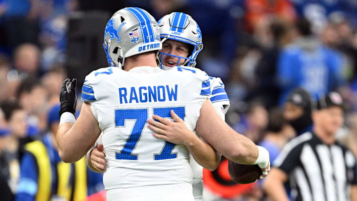 Detroit Lions quarterback Jared Goff (16) shares an embrace with center Frank Ragnow (77).