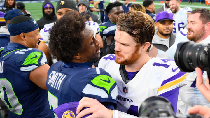 Seattle Seahawks quarterback Geno Smith (7) and Minnesota Vikings quarterback Sam Darnold (14) hug after the game at Lumen Field.