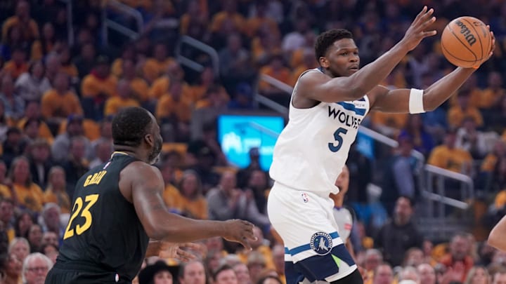 May 12, 2025; San Francisco, California, USA; Minnesota Timberwolves guard Anthony Edwards (5) holds onto the ball in front of Golden State Warriors forward Draymond Green (23) in the first quarter during game four of the second round for the 2025 NBA Playoffs at Chase Center.