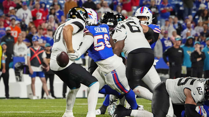 Sep 23, 2024; Orchard Park, New York, USA; Buffalo Bills defensive end Javon Solomon (56) knocks the ball away from Jacksonville Jaguars quarterback Mac Jones (10) during the second half at Highmark Stadium. 