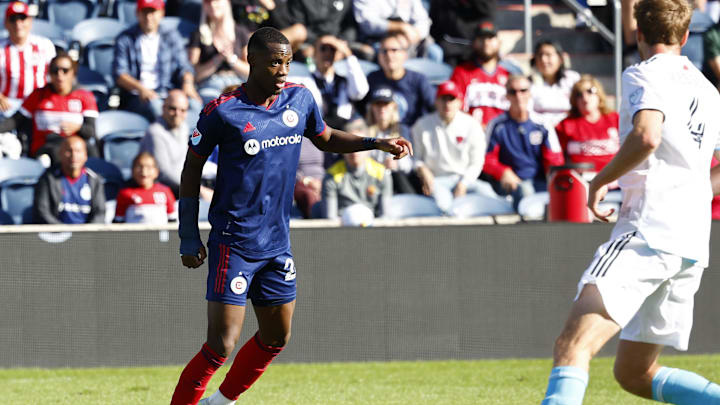 Oct 9, 2022; Chicago, Illinois, USA; Chicago Fire forward Jhon Duran (26) makes a pass against New England Revolution defender Henry Kessler (4) during the second half at Bridgeview Stadium. Mandatory Credit: Mike Dinovo-Imagn Images