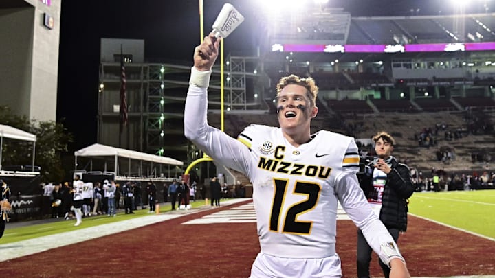 Nov 23, 2024; Starkville, Mississippi, USA; Missouri Tigers quarterback Brady Cook (12) reacts after defeating the Mississippi State Bulldogs at Davis Wade Stadium at Scott Field. Mandatory Credit: Matt Bush-Imagn Images