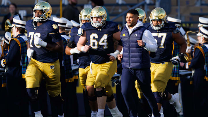 Notre Dame head coach Marcus Freeman takes the field with his players before a NCAA football game against Syracuse at Notre Dame Stadium on Saturday, Nov. 22, 2025, in South Bend.