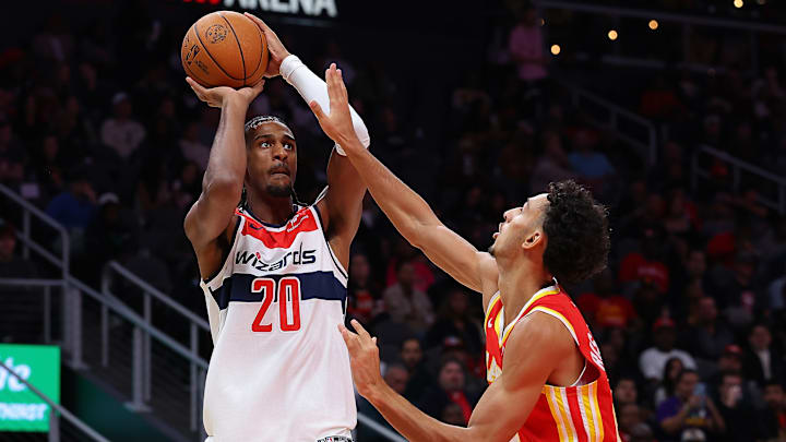 Alex Sarr #20 of the Washington Wizards shoots over Zacchrie Risacher #10 of the Atlanta Hawks.