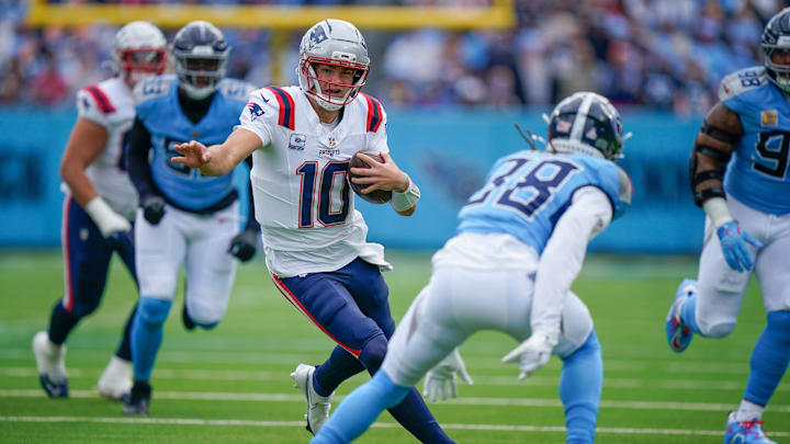 New England Patriots quarterback Drake Maye (10) runs around Tennessee Titans cornerback L'Jarius Sneed (38) during the first quarter at Nissan Stadium in Nashville, Tenn., Sunday, Oct. 19, 2025.