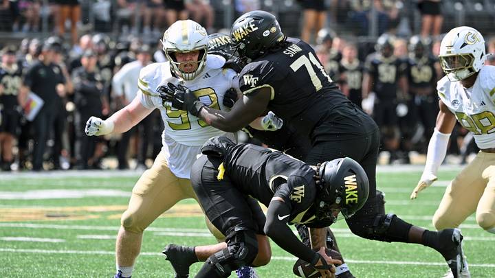 Sep 27, 2025; Winston-Salem, North Carolina, USA; Wake Forest Demon Deacons offensive lineman Melvin Siani (71) blocks Georgia Tech Yellow Jackets defensive lineman Jordan van den Berg (99) during the fourth quarter at Allegacy Federal Credit Union Stadium. Mandatory Credit: Zachary Taft-Imagn Images Sep 27, 2025; Winston-Salem, North Carolina, USA; Wake Forest Demon Deacons offensive lineman Melvin Siani (71) blocks Georgia Tech Yellow Jackets defensive lineman Jordan van den Berg (99) during the fourth quarter at Allegacy Federal Credit Union Stadium. Mandatory Credit: Zachary Taft-Imagn Images