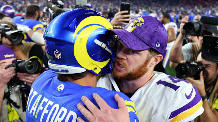 Jan 13, 2025; Glendale, AZ, USA; Minnesota Vikings quarterback Sam Darnold (14) and Los Angeles Rams quarterback Matthew Stafford (9) hug after the  NFC wild card game at State Farm Stadium. Mandatory Credit: Mark J. Rebilas-Imagn Images
