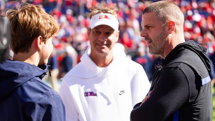 Florida Gators head coach Billy Napier talks with Mississippi Rebels head coach Lane Kiffin before the start of the game at Ben Hill Griffin Stadium in Gainesville, FL on Saturday, November 23, 2024. [Doug Engle/Gainesville Sun]
