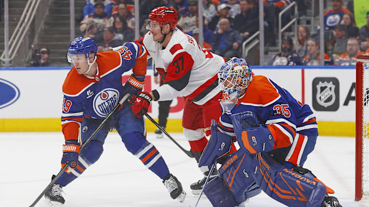 Mar 6, 2026; Edmonton, Alberta, CAN;  Carolina Hurricanes forward Andrei Svechnikov (37) battles with Edmonton Oilers defensemen Ty Emberson (49) in front of goaltender Tristan Jarry (35)during the second period at Rogers Place. Mandatory Credit: Perry Nelson-Imagn Images