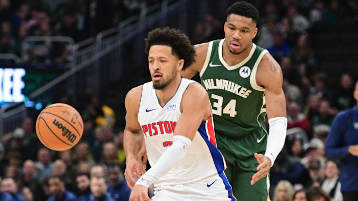 Dec 16, 2023; Milwaukee, Wisconsin, USA;  Detroit Pistons guard Cade Cunningham (2) is guarded by Milwaukee Bucks forward Giannis Antetokounmpo (34) in the first quarter at Fiserv Forum. Mandatory Credit: Benny Sieu-Imagn Images