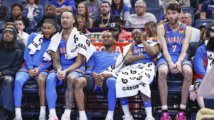 Apr 10, 2024; Oklahoma City, Oklahoma, USA; (L-R) Oklahoma City Thunder guard Isaiah Joe (11) and forward Jaylin Williams (6) and guard Shai Gilgeous-Alexander (2) and forward Jalen Williams (8) and forward Chet Holmgren (7) watch their team play against the San Antonio Spurs during the second half at Paycom Center. Mandatory Credit: Alonzo Adams-Imagn Images