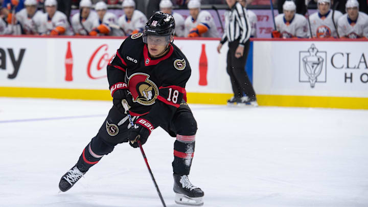 Dec 8, 2024; Ottawa, Ontario, CAN; Ottawa Senators center Tim Stutzle (18) moves the puck in the first period against the New York Islanders at the Canadian Tire Centre. Mandatory Credit: Marc DesRosiers-Imagn Images
