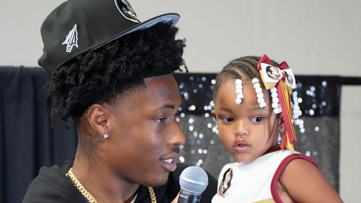 Friends and family celebrate after Booker High defensive end/wide receiver Chauncey Kennon announces he has selected Florida State University to commit to during a party Sunday afternoon, July 6, 2025 at the DeSoto Boys and Girls Club in Bradenton.