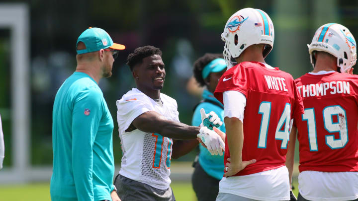 Jun 4, 2024; Miami Gardens, FL, USA; Miami Dolphins wide receiver Tyreek Hill (10) shakes hands with quarterback Mike White (14) during mandatory minicamp at Baptist Health Training Complex. Jun 4, 2024; Miami Gardens, FL, USA; Miami Dolphins wide receiver Tyreek Hill (10) shakes hands with quarterback Mike White (14) during mandatory minicamp at Baptist Health Training Complex.
