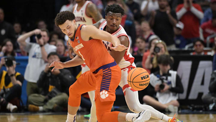 Mar 28, 2024; Los Angeles, CA, USA; Arizona Wildcats guard Jaden Bradley (0) fouls Clemson Tigers guard Chase Hunter (1) in the second half in the semifinals of the West Regional of the 2024 NCAA Tournament at Crypto.com Arena. Mar 28, 2024; Los Angeles, CA, USA; Arizona Wildcats guard Jaden Bradley (0) fouls Clemson Tigers guard Chase Hunter (1) in the second half in the semifinals of the West Regional of the 2024 NCAA Tournament at Crypto.com Arena.