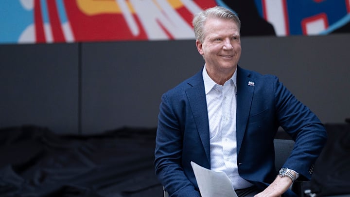 Aug 1, 2024; Hackensack, NJ, USA; Former Giants quarterback Phil Simms during a ceremony to unveil a mural celebrating the New York Giants 100th season at Hackensack University Medical Center. Aug 1, 2024; Hackensack, NJ, USA; Former Giants quarterback Phil Simms during a ceremony to unveil a mural celebrating the New York Giants 100th season at Hackensack University Medical Center.
