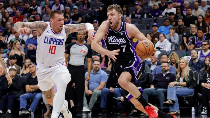 Apr 2, 2024; Sacramento, California, USA; Sacramento Kings forward Sasha Vezenkov (7) drives to the basket against LA Clippers center Daniel Theis (10) during the second quarter at Golden 1 Center. Apr 2, 2024; Sacramento, California, USA; Sacramento Kings forward Sasha Vezenkov (7) drives to the basket against LA Clippers center Daniel Theis (10) during the second quarter at Golden 1 Center.