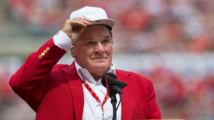 An emotional Cincinnati Reds hall of famer Pete Rose adjusts his cap as he takes the microphone during a pregame ceremony for the unveiling of Pete Rose's bronze statue being installed outside the stadium before the MLB National League game between the Cincinnati Reds and the Los Angeles Dodgers at Great American Ball Park in downtown Cincinnati.
