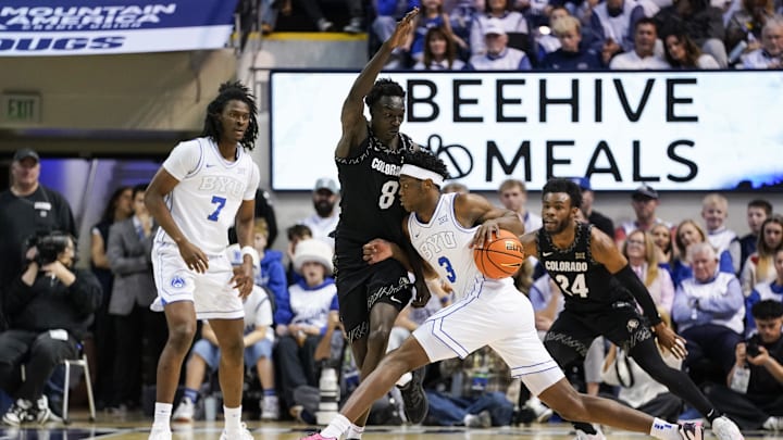 Feb 14, 2026; Provo, Utah, USA; BYU Cougars forward AJ Dybantsa (3) controls the ball while being defended by Bangot Dak (8) of the Colorado Buffaloes at the Marriott Center. Mandatory Credit: Aaron Baker-Imagn Images
