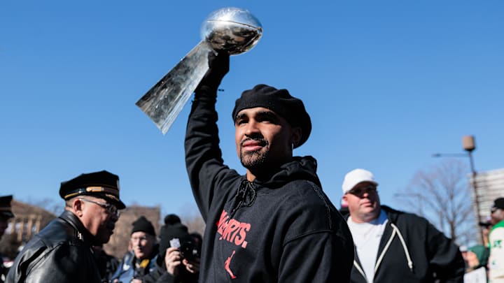 Feb 14, 2025; Philadelphia, PA, USA; Philadelphia Eagles quarterback Jalen Hurts (1) raises the Lombardi Trophy during the Super Bowl LIX championship parade and rally. Mandatory Credit: Caean Couto-Imagn Images