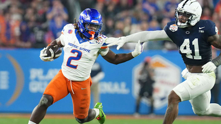 Boise State Broncos running back Ashton Jeanty (2) runs past Penn State Nittany Lions linebacker Kobe King (41) during their Vrbo Fiesta Bowl matchup at State Farm Stadium on Dec. 31, 2024.