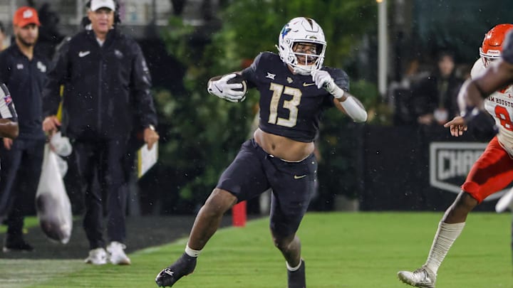 Sep 7, 2024; Orlando, Florida, USA; UCF Knights running back Peny Boone (13) runs the ball during the second half against the Sam Houston State Bearkats at FBC Mortgage Stadium. Mandatory Credit: Mike Watters-Imagn Images