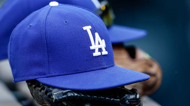 Apr 9, 2017; Denver, CO, USA; A general view of a Los Angeles Dodgers hat and glove on the bench in