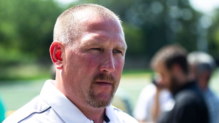 Iowa offensive line coach Tim Polasek talks with reporters during Hawkeyes football media day