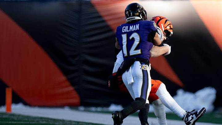 Baltimore Ravens safety Alohi Gilman (12) tackles Cincinnati Bengals tight end Tanner Hudson (87) in the third quarter of the NFL football game at Paycor Stadium in Cincinnati on Dec. 14, 2025.