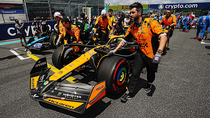 May 4, 2024; Miami Gardens, Florida, USA; Crewmembers push the car of McLaren driver Lando Norris