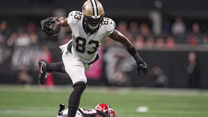 Sep 29, 2024; Atlanta, Georgia, USA; New Orleans Saints tight end Juwan Johnson (83) jumps over Atlanta Falcons cornerback Dee Alford (20) during the second half at Mercedes-Benz Stadium. Mandatory Credit: Dale Zanine-Imagn Images Sep 29, 2024; Atlanta, Georgia, USA; New Orleans Saints tight end Juwan Johnson (83) jumps over Atlanta Falcons cornerback Dee Alford (20) during the second half at Mercedes-Benz Stadium. Mandatory Credit: Dale Zanine-Imagn Images