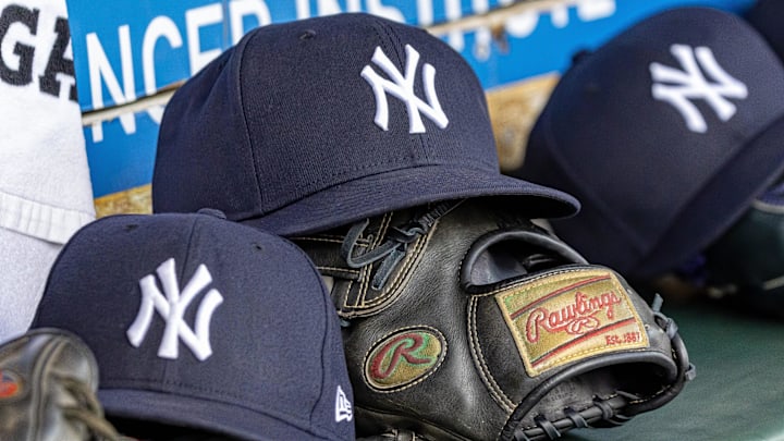 Apr 7, 2025; Detroit, Michigan, USA; New York Yankees baseball hats and gloves in the dugout out in the eighth inning against the Detroit Tigers at Comerica Park. 