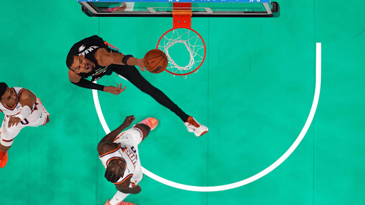 Feb 19, 2026; Austin, Texas, USA; San Antonio Spurs forward Victor Wembanyama (1) dunks over Phoenix Suns forwards Rasheer Fleming (20) and Ryan Dunn (0) during the second half at Moody Center. Mandatory Credit: Scott Wachter-Imagn Images