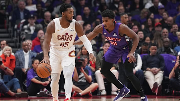 Oct 23, 2024; Toronto, Ontario, CAN; Cleveland Cavaliers guard Donovan Mitchell (45) controls the ball as Toronto Raptors guard Ochai Agbaji (30) defends during the first quarter at Scotiabank Arena.