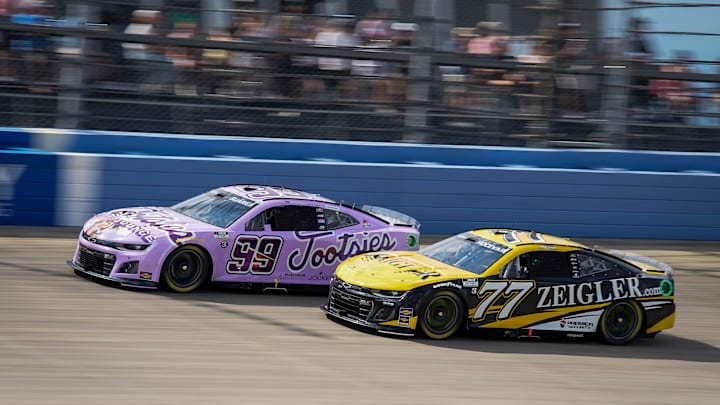 NASCAR Cup Series driver Daniel Suarez (99) work past driver Carson Hocevar (77) during the Ally 400 at Nashville Superspeedway in Lebanon, Tenn., Sunday, June 30, 2024.