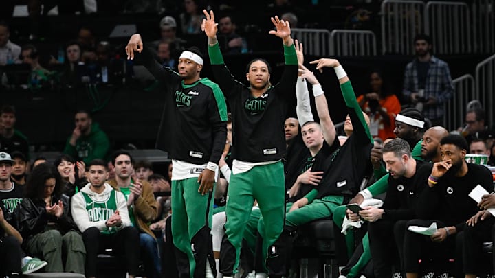 Apr 11, 2025; Boston, Massachusetts, USA; Boston Celtics forward Torrey Craig (12) (left) and guard JD Davison (20) (right) react to game action against the Charlotte Hornets during the second half at TD Garden. Mandatory Credit: Eric Canha-Imagn Images
