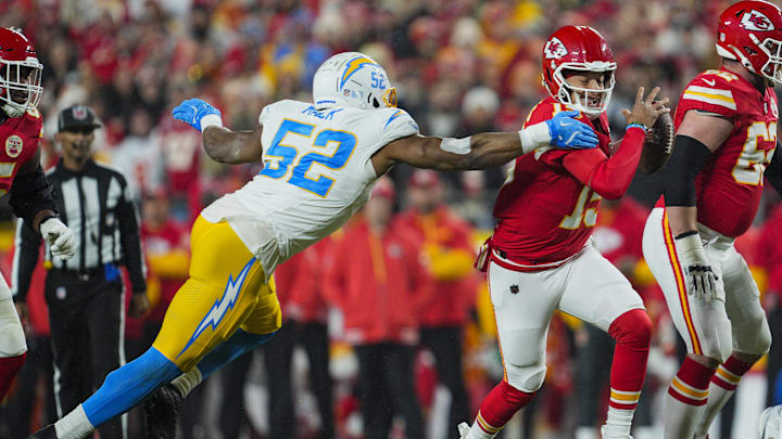 Dec 8, 2024; Kansas City, Missouri, USA; Kansas City Chiefs quarterback Patrick Mahomes (15) scrambles against Los Angeles Chargers linebacker Khalil Mack (52) during the first half at GEHA Field at Arrowhead Stadium. Mandatory Credit: Jay Biggerstaff-Imagn Images