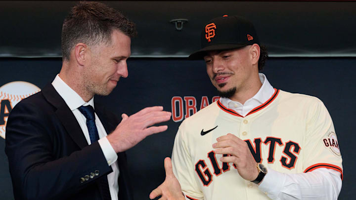 Dec 12, 2024; San Francisco, CA, USA; San Francisco Giants shortstop Willy Adames shakes hands with president of baseball operations Buster Posey during his introductory press conference at Oracle Park.