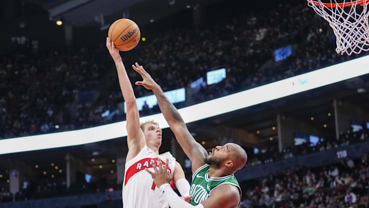 Oct 15, 2024; Toronto, Ontario, CAN; Toronto Raptors guard Gradey Dick (1) shoots against Boston Celtics forward Xavier Tillman (26) during the second half at Scotiabank Arena. Mandatory Credit: Kevin Sousa-Imagn Images