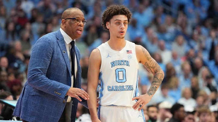 Feb 28, 2026; Chapel Hill, North Carolina, USA; North Carolina Tar Heels head coach Hubert Davis with guard Kyan Evans (0) in the second half at Dean E. Smith Center. Mandatory Credit: Bob Donnan-Imagn Images