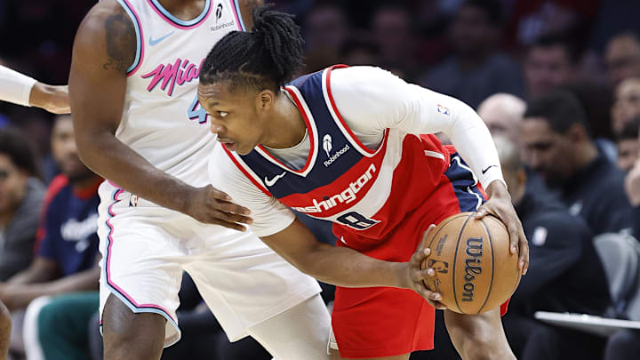 Apr 13, 2025; Miami, Florida, USA;  Miami Heat guard Davion Mitchell (45) defends Washington Wizards guard Bub Carrington (8) during the first half at Kaseya Center. Mandatory Credit: Rhona Wise-Imagn Images
